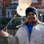 Resident holding balloon for The Old Vicarage's first birthday